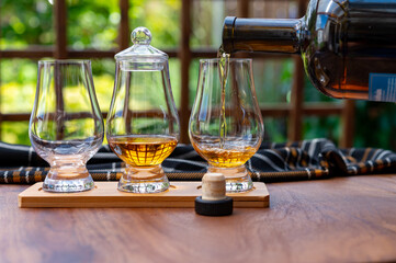 Tasting of Scotch whisky in traditional old British house with wooden windows