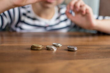 Fototapeta na wymiar child hand counting money, saving money concept