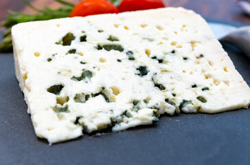 French cheeses collection, piece of roquefort, sheep milk soft blue cheese from Southern France.