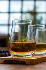 Tasting of Scotch whisky in traditional old British house with wooden windows