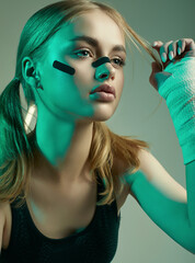 strong beautiful girl with blonde hair, confident look, fists in protective boxing bandages