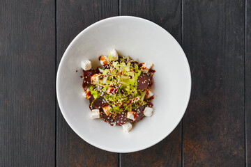 Salad with boiled beet, cabbage, feta cheese, sesame and barbecue sauce