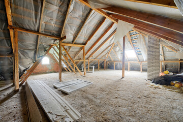 Fototapeta premium Empty dusty attic of a house with wooden beams