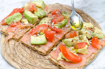 Avocado toast salmon tomato and olive oil
