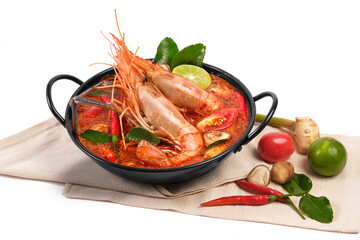 Thai food Tom Yum Kung.Thai hot and spicy soup shrimp in bowl.with Straw Mushroom,lime,Kaffir lime leaves,tomato and chilli. Splash on the air. isolated on white background.