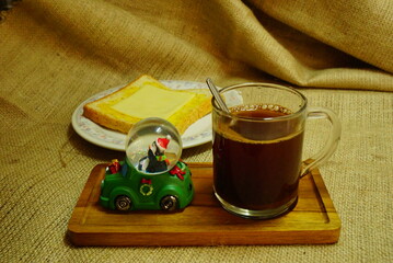 Breakfast in Christmas time : black coffee, cheese bread and santa.