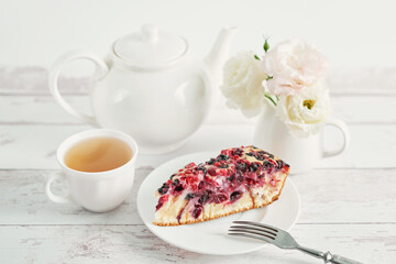 Homemade flavored pie with currants and gooseberries. Delicious tart on white wooden background, top view. Healthy eating and food. Summer fruit dessert. Bake fruit cake. Delicious homemade pie