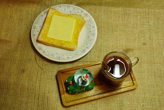 Breakfast in Christmas time : black coffee, cheese bread and santa.