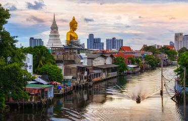 BANGKOK, THAILAND - JUNE 16, 2020 : The big golden buddha statue under construction seen from a distance at Khlong Bangkok Yai, Bangkok, Thailand. - obrazy, fototapety, plakaty