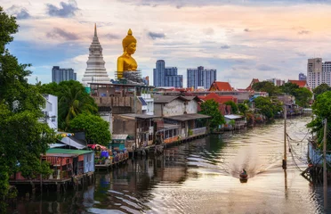 Fototapeten BANGKOK, THAILAND - JUNE 16, 2020 : The big golden buddha statue under construction seen from a distance at Khlong Bangkok Yai, Bangkok, Thailand. © somchairakin