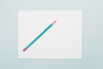 a blank sheet with a pencil on a blue background. life with a clean slate
