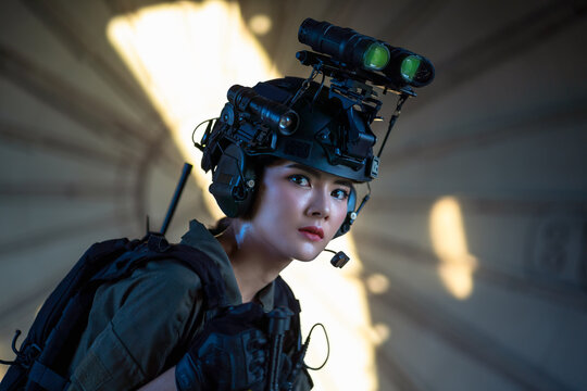 Portrait Of Female Modern Army Special Forces Soldier, Anti Terrorist Squad Fighter, Elite Commando Warrior Using Four-eyed Night Vision Goggles In Dark Background