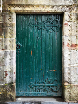 An ancient green wooden door in Scotland, UK. 