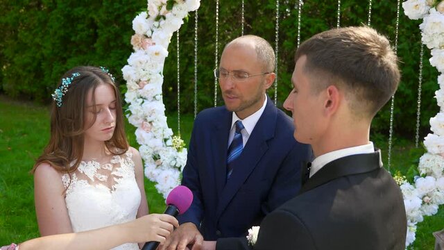 Pastor Praying and Blessing Bride and Groom at Wedding Ceremony on Nature in Park. 2x Slow motion - 0,5 Speed 60 FPS 4K