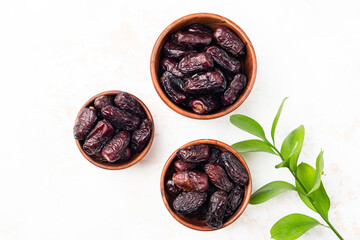Dried dates in wooden bowl isolated on white background. Medjool dates