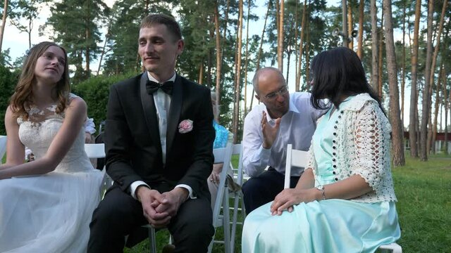 Newlyweds Bride and Groom Spend Time with Guests at Wedding Ceremony on Nature. 2x Slow motion - 0,5 Speed 4K 60 FPS