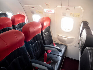 Emergency exit window in aircraft cabin. Long leg room seat. premium seat. Emergency exit seat.
