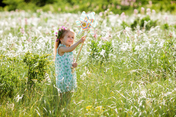 Fototapeta premium Cute little girl smiling summer in the field holding a baby tinge