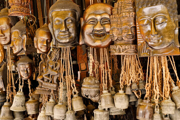 Fototapeta premium Souvenir masks and bells for sale in open-air market, Siem Reap, Cambodia