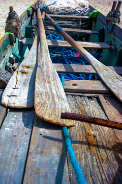 Old wooden fishing boat, detail, paddle, defocused ropes