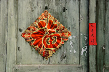 Hanging Chinese New Year decoration on doors is believed to bring good luck and prosperity in the coming year — Xingping, Guangxi Province, China