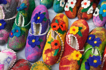 Fototapeta na wymiar Colorful floral-design wool slippers for sale by a street vendor in Old Town, Tbilisi, Georgia