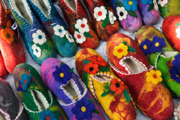 Fototapeta na wymiar Colorful floral-design wool slippers for sale by a street vendor in Old Town, Tbilisi, Georgia
