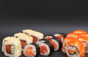 Japanese rolls on black stone background.