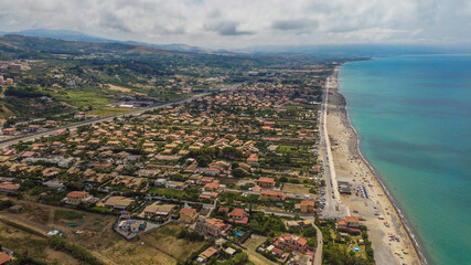 Aerial view of the Villa in Campofelice di Roccella in Sicily, under a beautiful sunny sky, with swimming pools and trees.