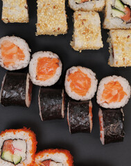 Japanese rolls on black stone background.