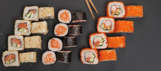 Japanese rolls on black stone background.