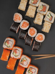 Japanese rolls on black stone background.