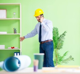 Young male architect working at the project