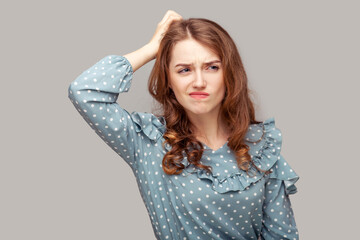 Hmm, need to think! Thoughtful confused brunette girl ruffle blouse scratching head having doubts,...