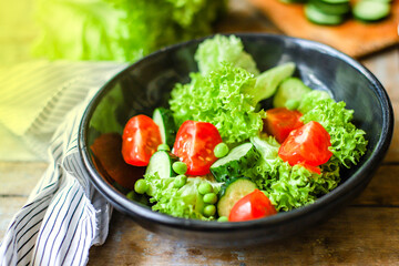 Healthy salad leaves mix vegetables (mix micro greens, juicy snack, tomato). food background copy space for text organic healthy eating keto or paleo diet