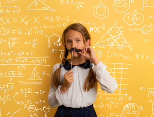 Young student acts like a senior teacher and wants to solve an advance math problem. Yellow studio background