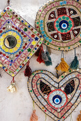 Colorful beaded and embroidered wool handicrafts with cowry shells are displayed for sale in Hasankeyf, Turkey