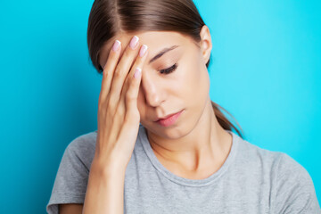 Head pain, exhausted young woman has suffering from unbearable headache