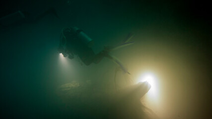 The scuba girl's vision is clouded inside the cloud of sulfide acid from the Mexican cenote. Yucatan (Mexico)