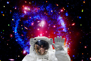 Astronaut and galaxy on the backdrop. The elements of this image furnished by NASA.