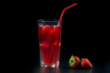 Fresh strawberry cocktail with strawberries on a dark background, close-up. Fresh fruit lemonade.