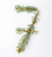 number 7 from green christmas-tree isolated on white. Natural number seven, stylish alphabet. Handmade abc. Text from spruce. Christmas winter Sale. X-mas numbers. Winter font. 