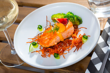 Fried trout steak with carrot brushwood, broccoli, cucumber, figs