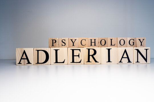 Adlerian psychology text from wooden cubes. Close up.