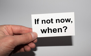 Message on the card IF NOT NOW, WHEN in hands of businessman.