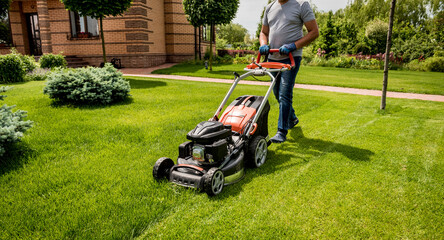 Gardener mowing the lawn. Landscape design. Green background - obrazy, fototapety, plakaty