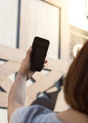 Female taking a photo with smart phone.