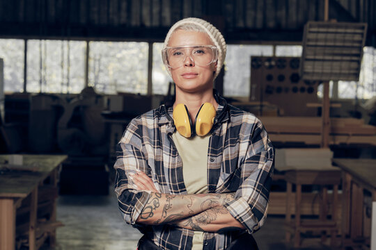 Portrait of female carpenter wearing protective eyewear