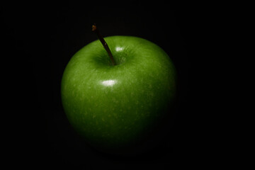 Close-Up Of Green Apple Over Black Background