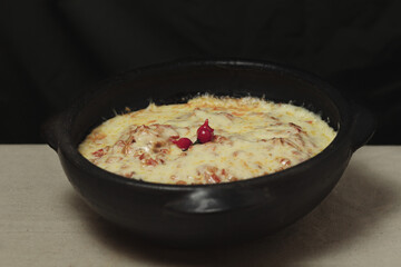 Moqueca - fish with sauce covered with cheese